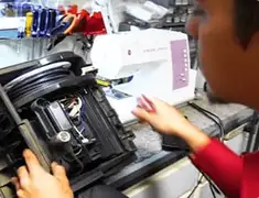 Vacuum repair technician servicing internal components on a workbench in Austin, TX